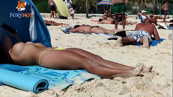 Gorące Sunbathing topless on the beach to be watched by other men nowe filmy